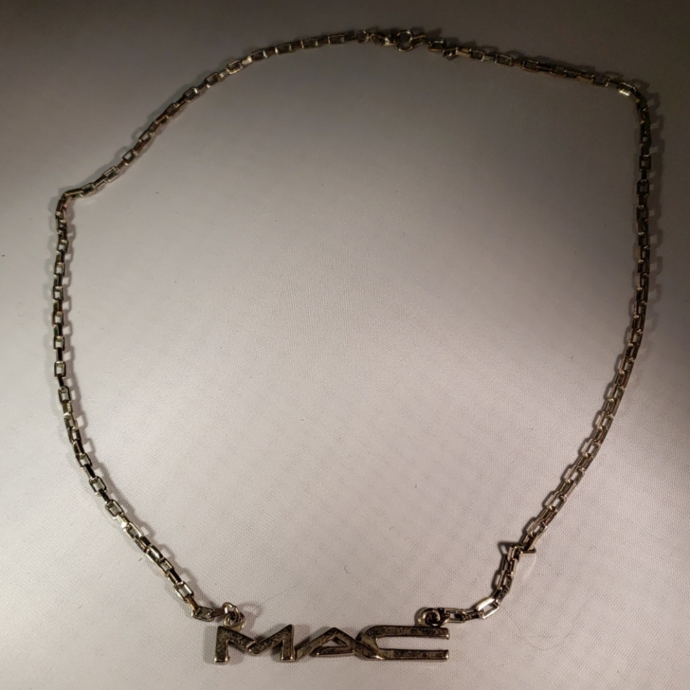 MAC silver toned employee necklace.